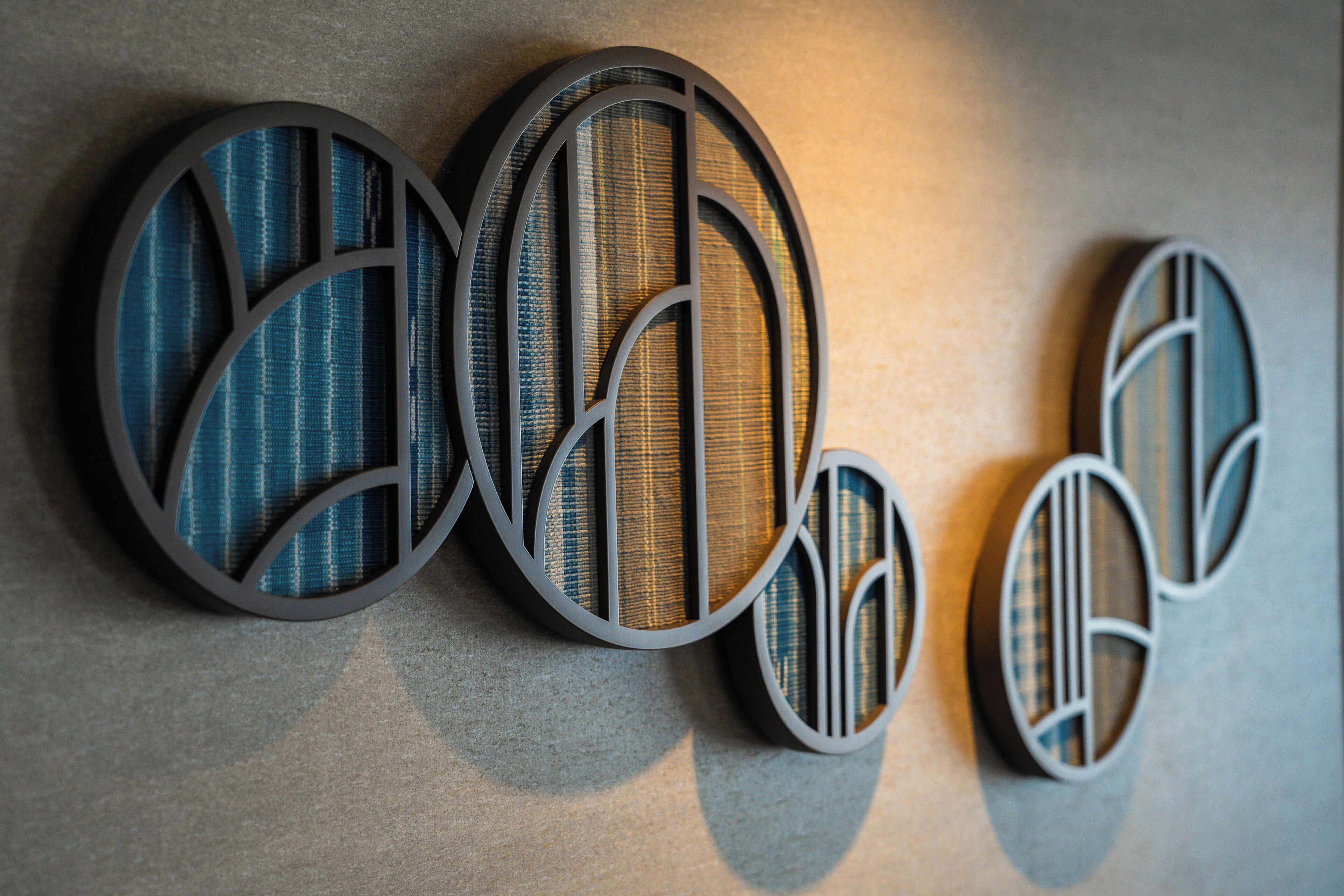 A wall with three circular designs, each with a different pattern.
