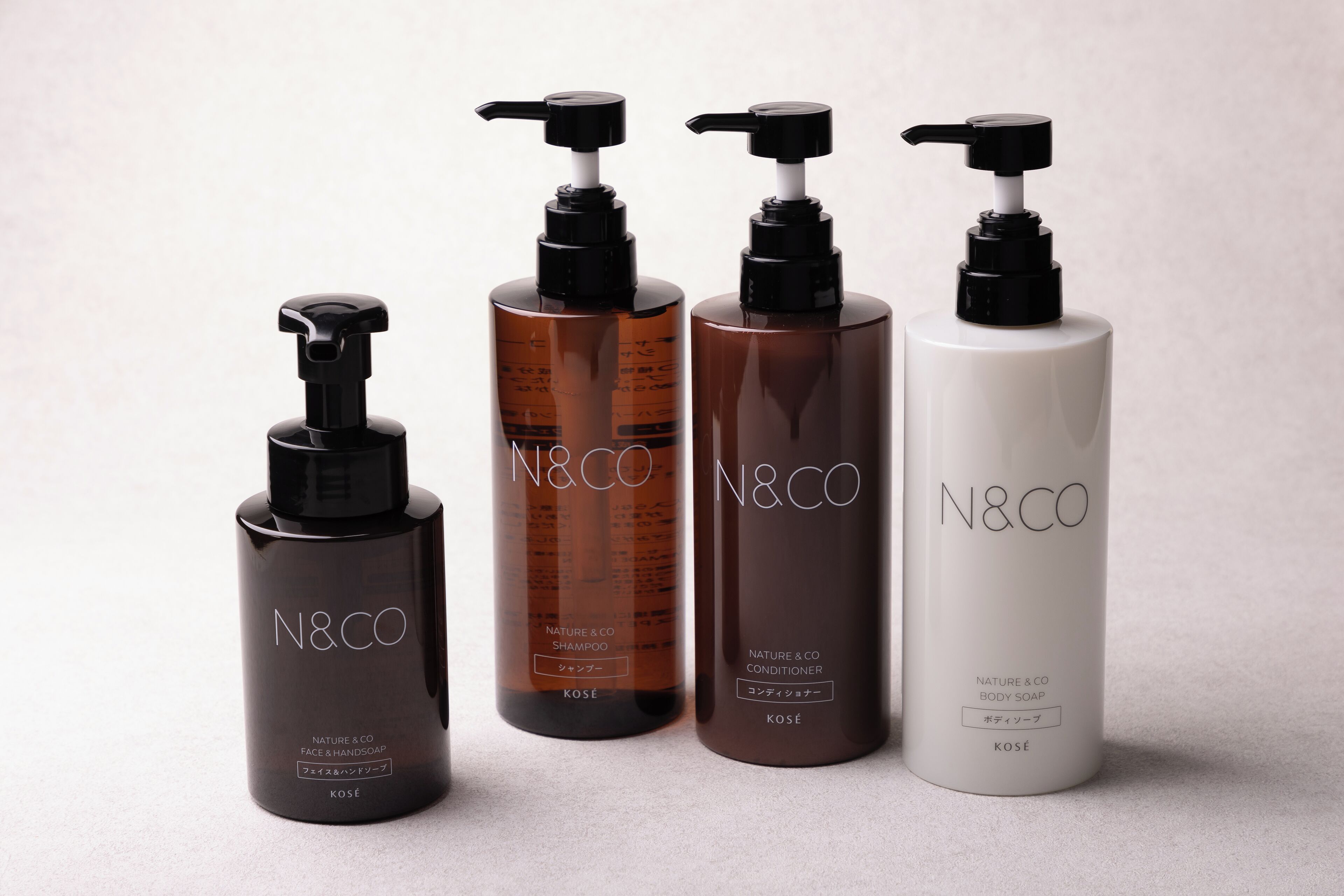 Four N&CO product bottles with pumps, arranged in a row.