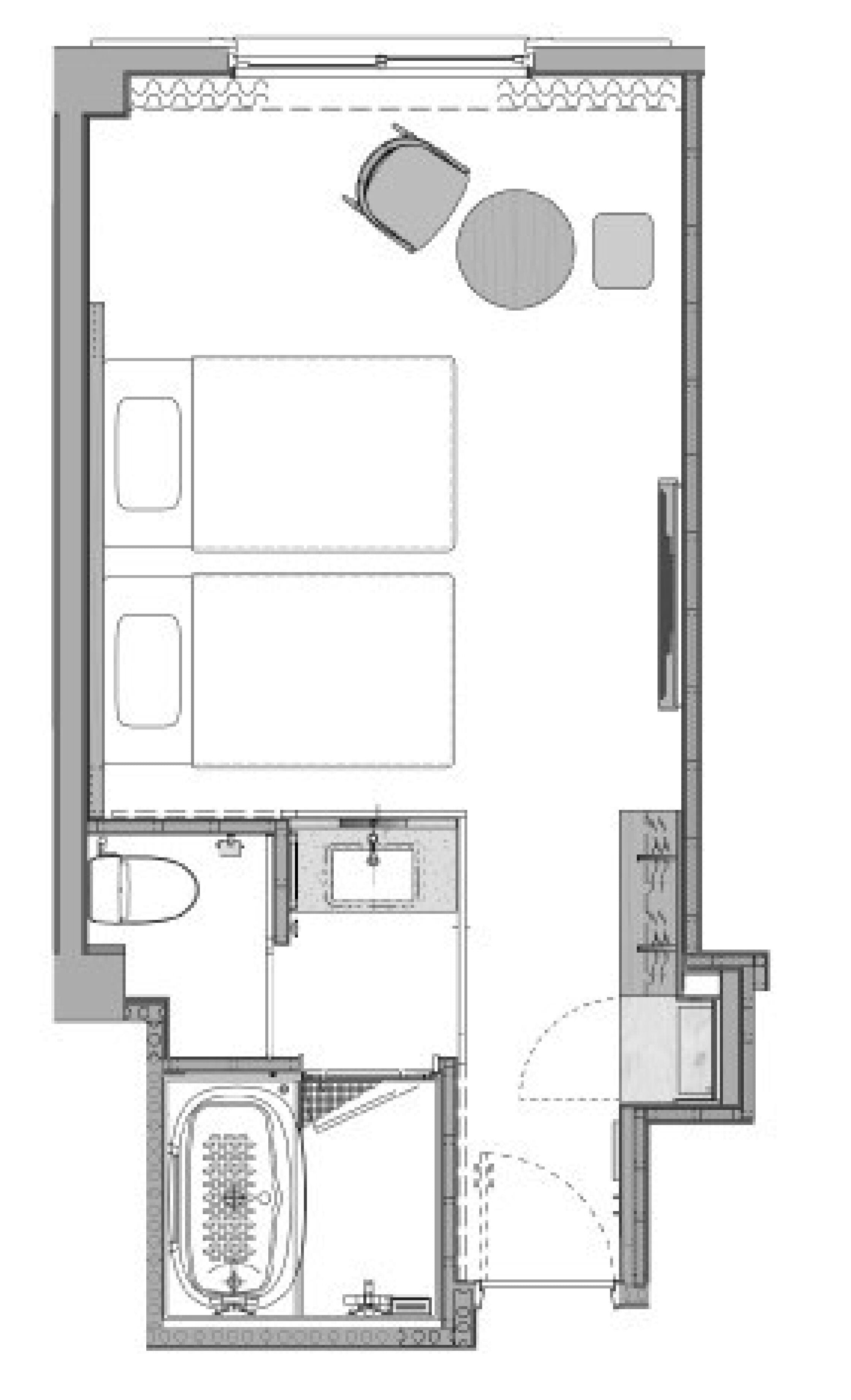 A floor plan of a hotel room with a bathroom, a living area with a sofa and a coffee table, a small kitchen area, and a separate bathroom with a bathtub.