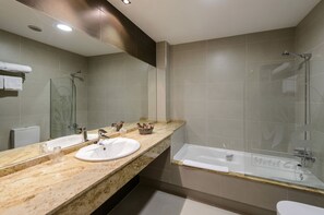 Bañera, artículos de tocador gratuitos, pantuflas, bidet