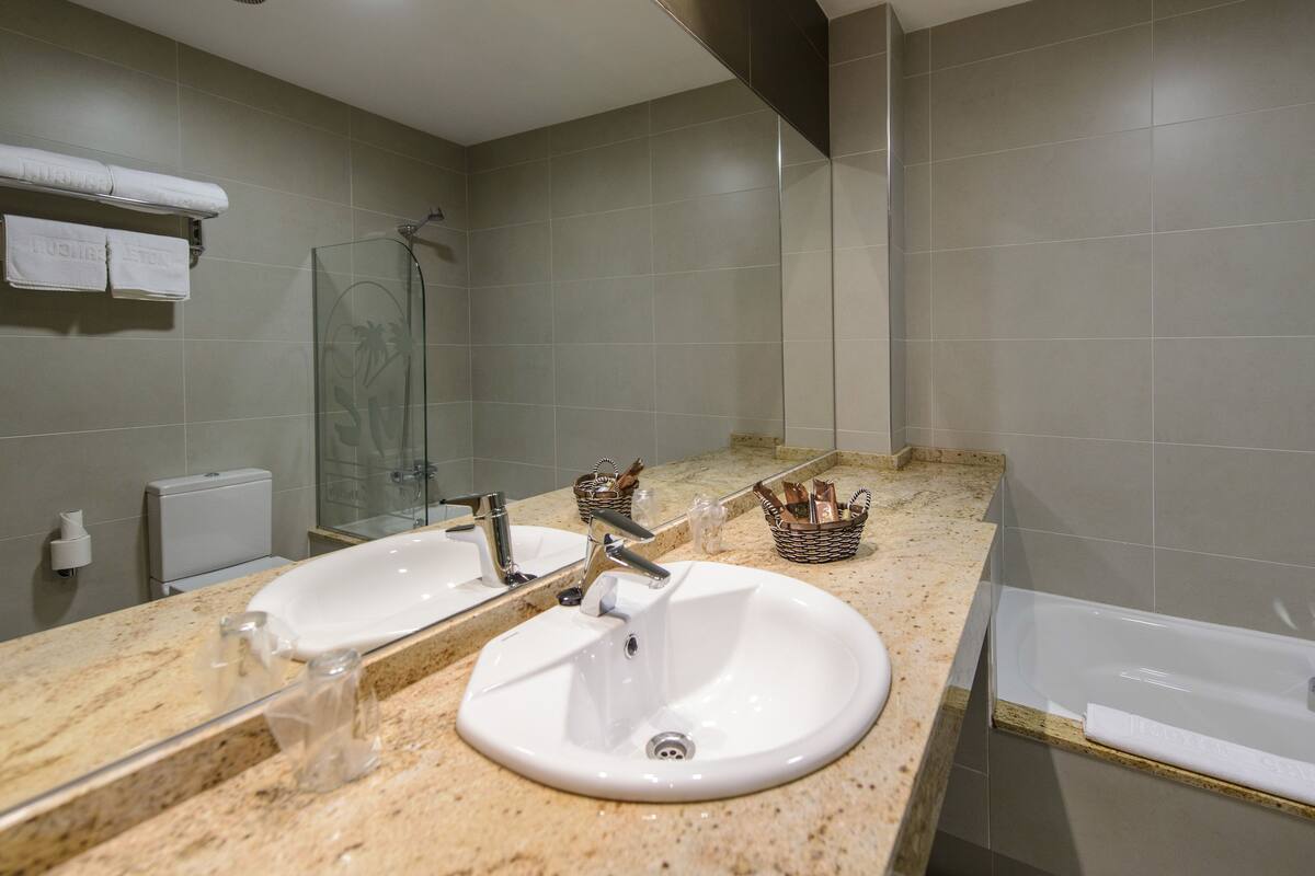 bathtub, free toiletries, slippers, bidet