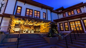 A multi-story building with a wooden facade, large windows, and a staircase leading to the entrance. - Omm Inn (Eskisehir)