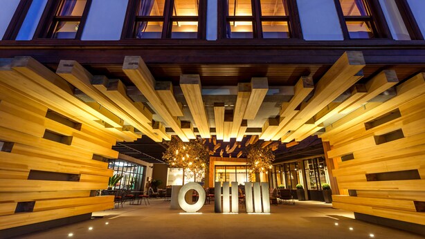 A modern building with a wooden facade, large windows, and a central circular structure. - Omm Inn (Eskisehir)