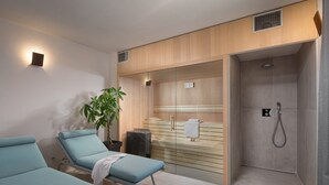 A modern spa room with two massage chairs, a glass-enclosed shower, and a potted plant. - Corto Bechera (Bale)