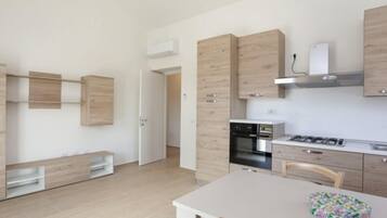 Apartment, 2 Bedrooms | Private kitchen | Full-sized fridge, oven, stovetop, cookware/dishes/utensils
