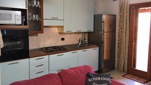 Apartment, 3 Bedrooms | Private kitchen | Espresso maker, full-size fridge, oven, stovetop - Delfino House (San Teodoro)
