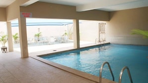 An indoor swimming pool with a sign indicating no children allowed. - Marvel Hotel  Suites (Abuja)