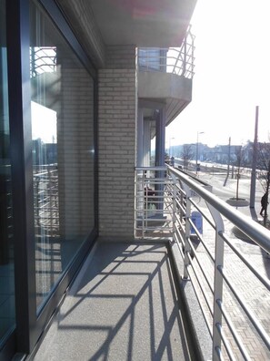 A modern building with large windows, a brick facade, and a metal railing overlooking a snowy landscape. - Kompas 1 0102 (Nieuwpoort)