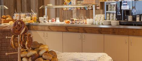 A breakfast buffet with various food items and a coffee machine.