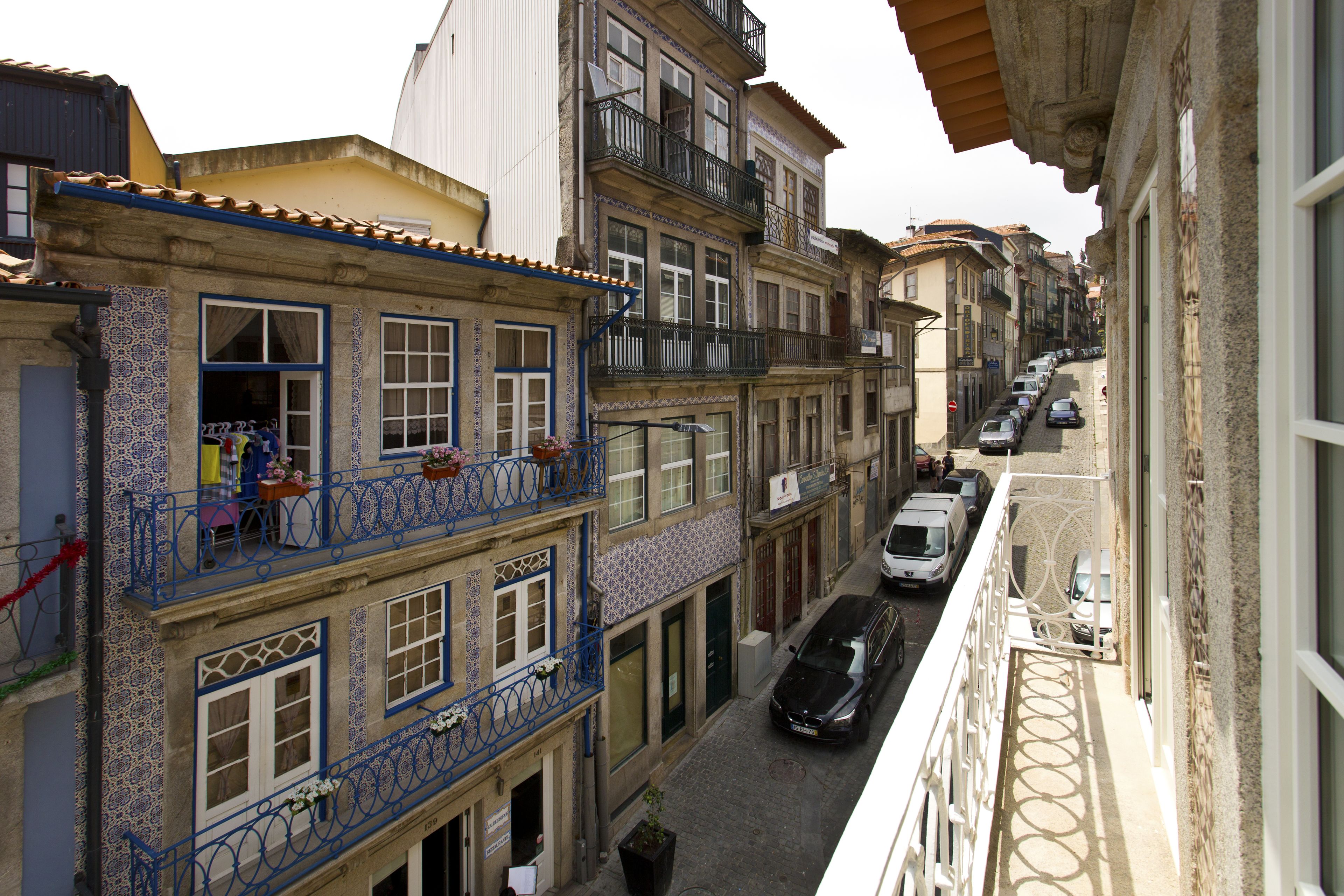 Eine enge Straße mit Häusern, die Balkone und traditionelle Architektur aufweisen.