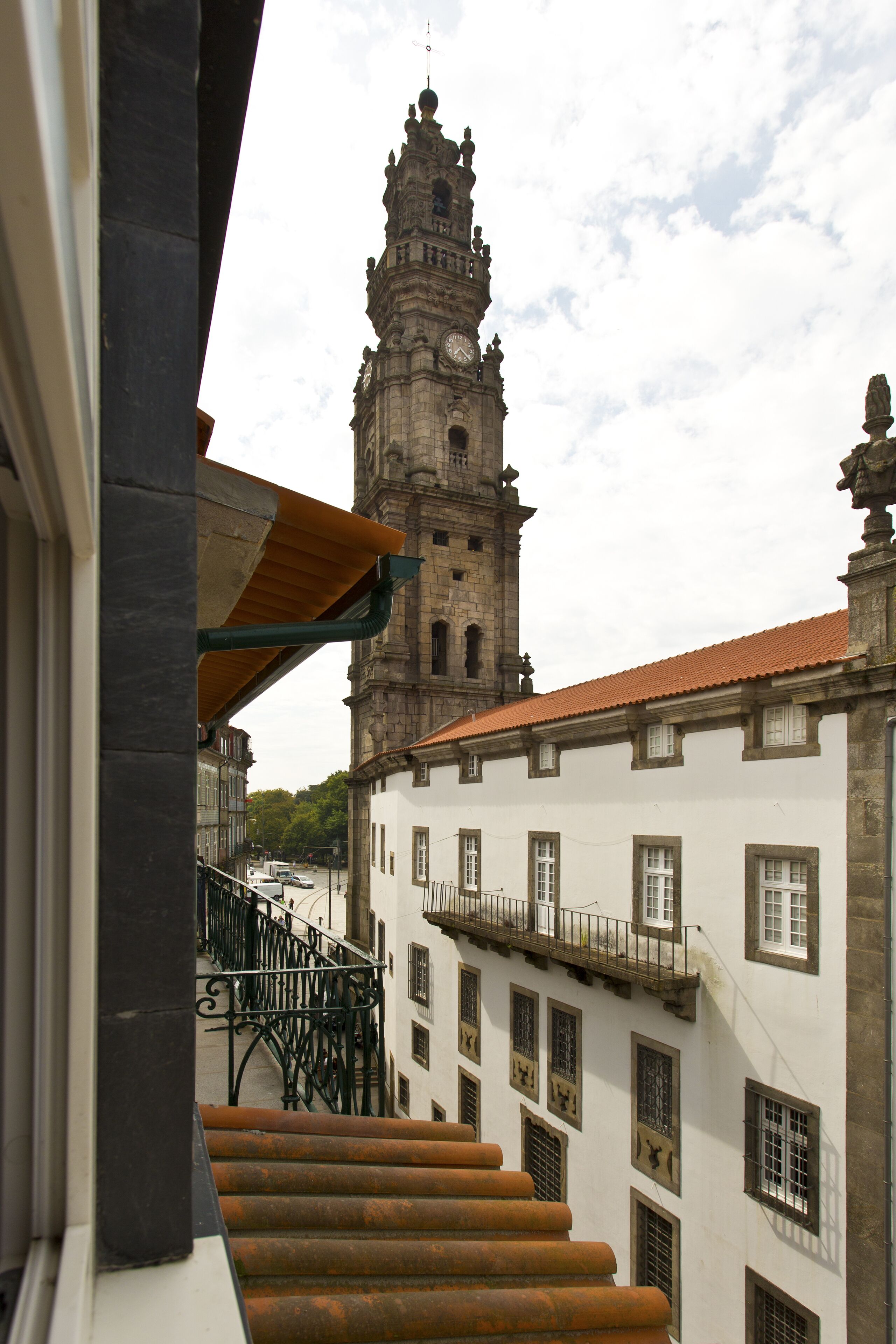 A staircase leading to a building with a clock tower in the background.