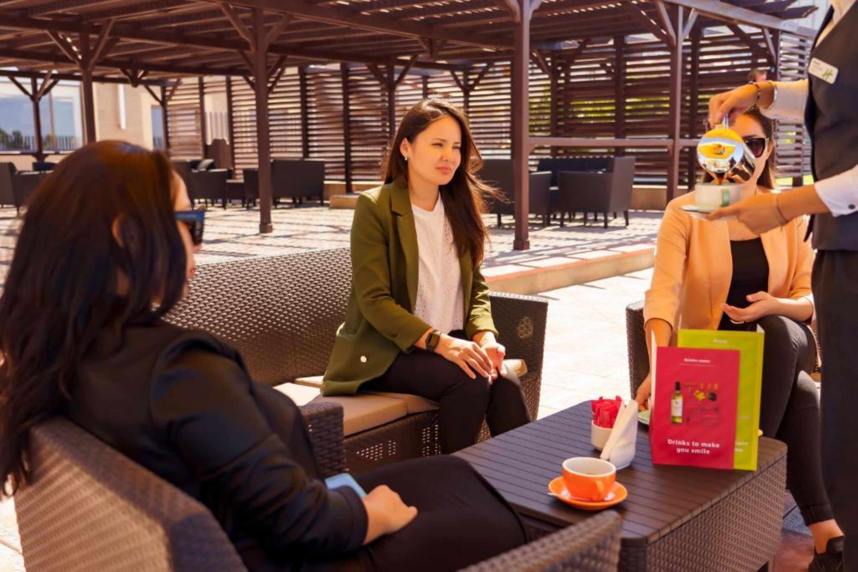 An outdoor seating area with wicker furniture and a covered structure. - Holiday Inn Aktau - Seaside by IHG (Aktau)