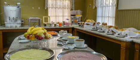 A buffet setup with various food items and beverages.
