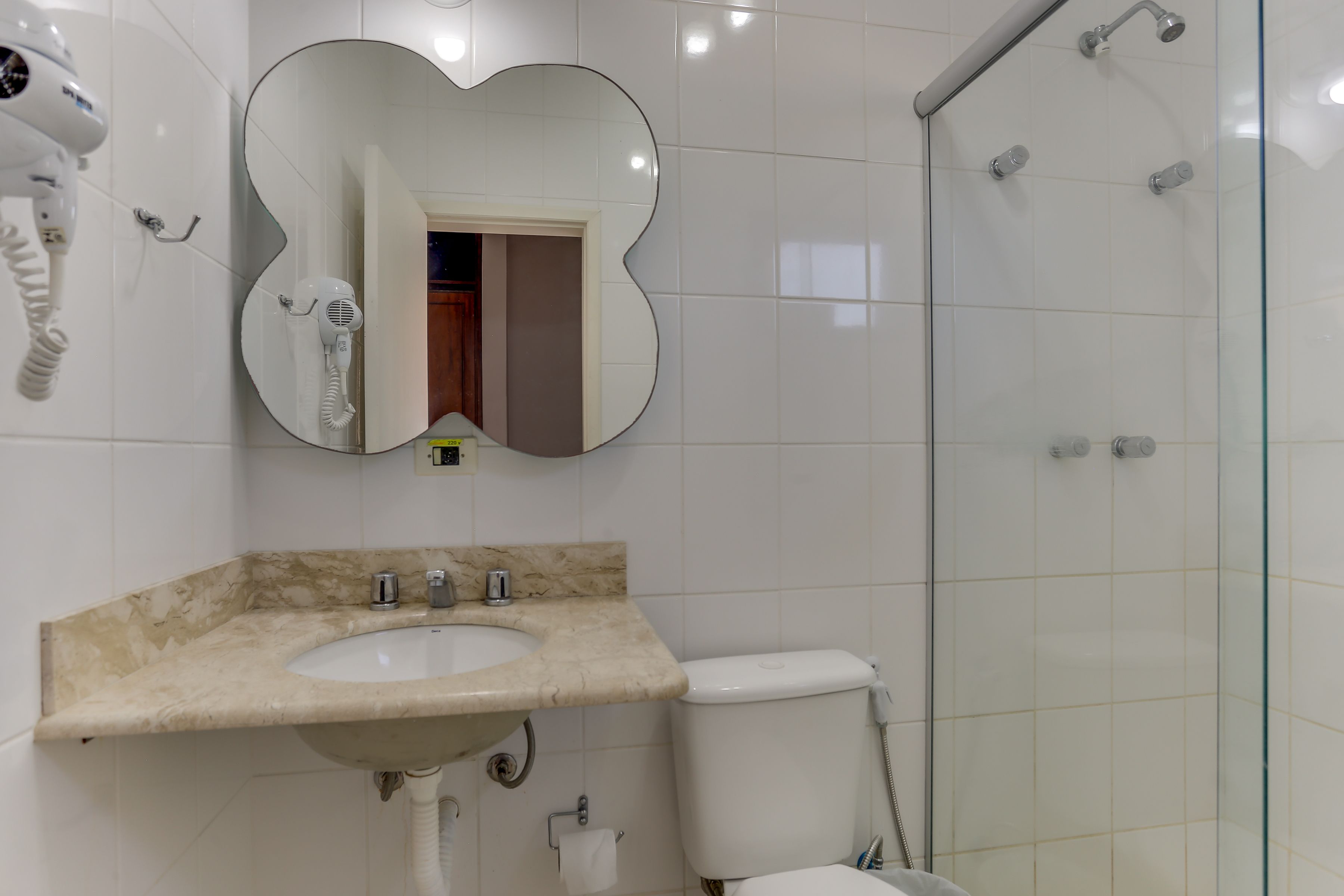A bathroom with a sink, toilet, and shower.