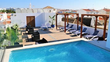 Outdoor pool, open 9:00 AM to 9:00 PM, pool loungers