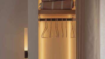 A neatly organized closet with a hanging rack and folded towels.