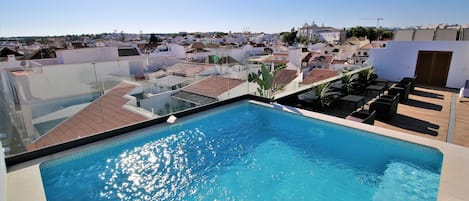 Outdoor pool, open 9:00 AM to 9:00 PM, pool loungers