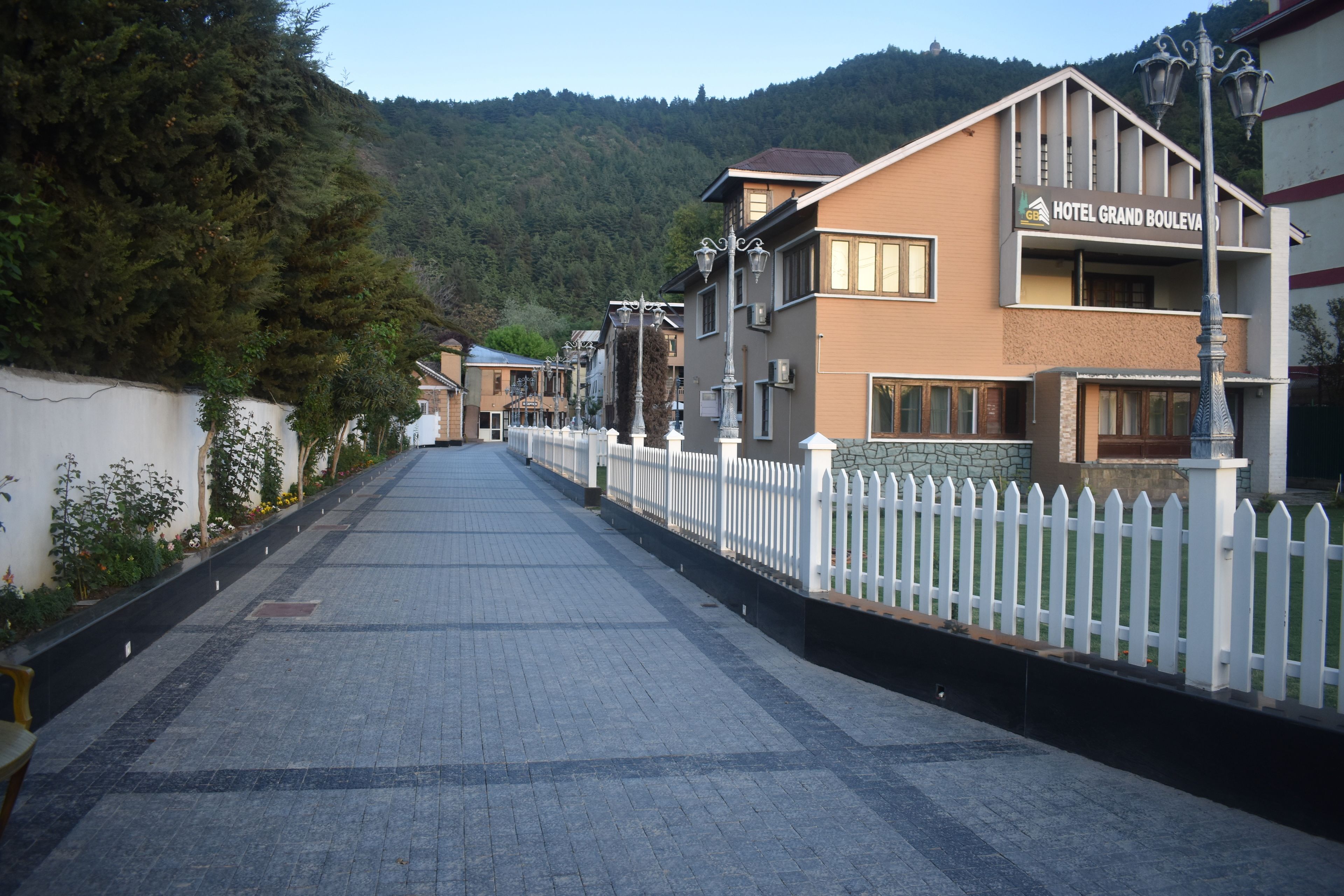 A paved street lined with buildings, including a hotel named "Hotel Grand Boulevard."