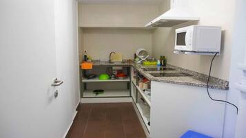 Full-sized fridge, microwave, stovetop, cookware/dishes/utensils