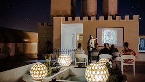 A castle-themed outdoor area with seating and a presentation screen. - Desert Moon (Giza)