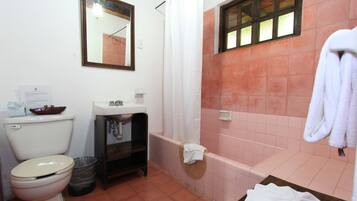 A bathroom with a toilet, sink, and bathtub.