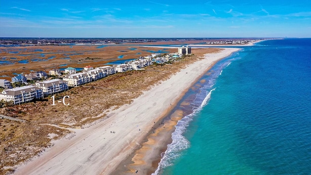 An aerial view of a coastal hotel with a beachfront, sandy beach, and ocean. - Oceanfront Condo with Ocean Views (Wrightsville Beach)