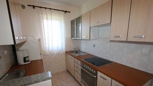 A kitchen with a sink, stove, and cabinets. - Apartment Dudovic Darko nr 3 (Silo - island Krk)