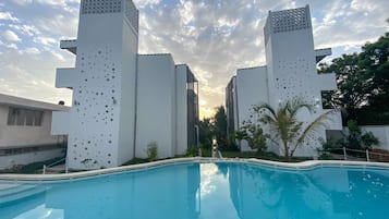 Outdoor pool, open 9:00 AM to 7:00 PM, pool umbrellas, pool loungers