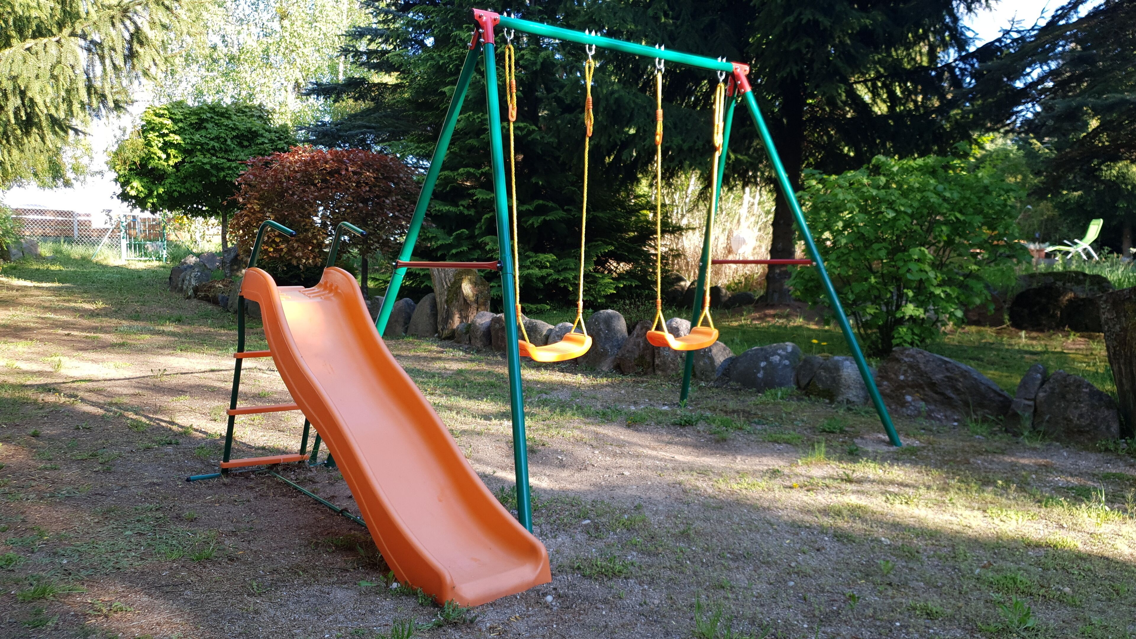 A playground with a slide and swings.