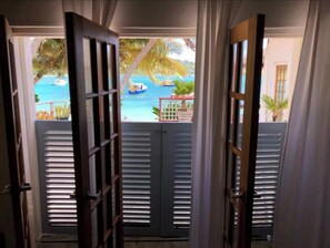 Enjoy an outdoor space with a view of the pool and palm trees from the comfort of your room.