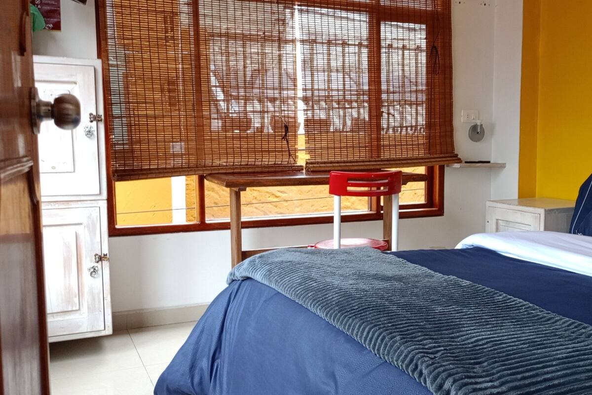 Une chambre à coucher avec un lit, un bureau et une chaise.