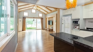 A spacious kitchen with modern appliances, a large island, and a view to the outdoors. - Gyeongju Woorinuri Pension (Gyeongju)