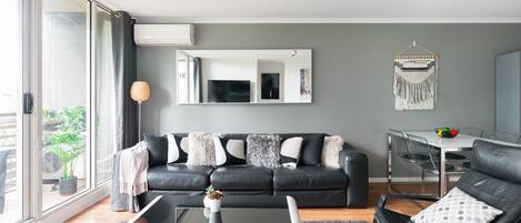 Spacious & Stylish Apartment with Balcony, Tennis, Gym, Pool | Living room | 55-inch Smart TV with digital channels, TV, video-game console