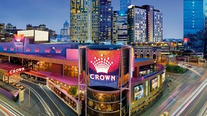 A multi-story hotel with a prominent 'Crown' sign, surrounded by high-rise buildings and busy streets. - Southbank Boulevard Melbourne (Southbank)