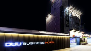 The exterior of the Duu Business Hotel with a prominent sign and a building in the background. - Business Hotel Duu (Gwangju)
