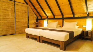 A cozy bedroom with a wooden ceiling, a large bed with white linens, and a nightstand with a lamp. - Go Go Green Resort (Habarana)