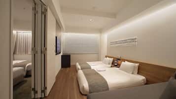 A hotel room with two beds, a wooden headboard, a large window with blinds, a flat-screen TV, and a small bedside table.