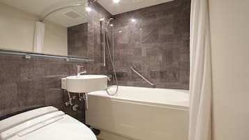 A modern bathroom with a bathtub, toilet, and sink.