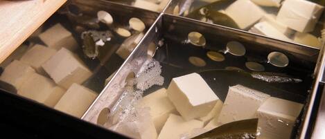 A container with ice cubes and a wooden object.
