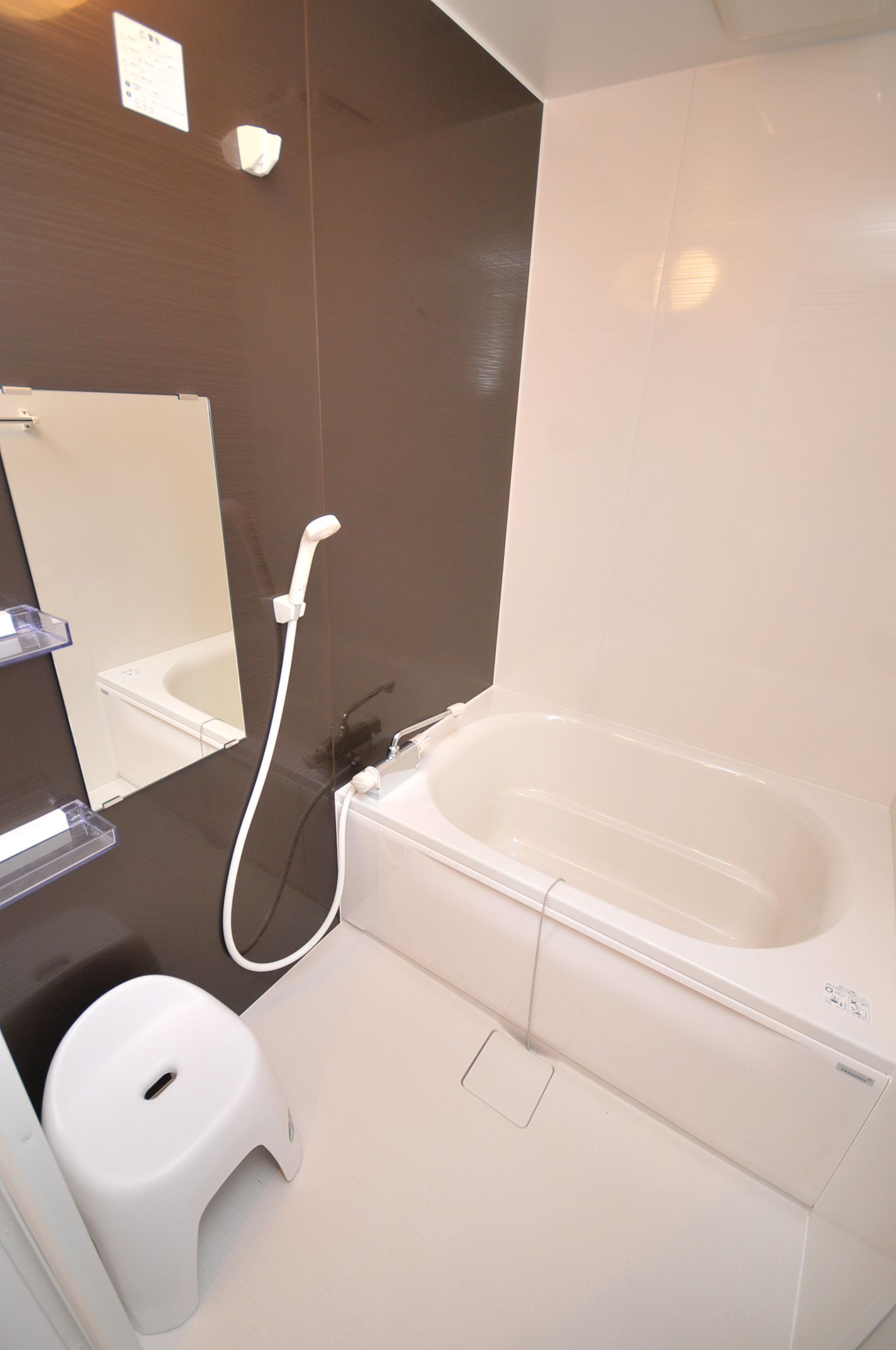 A modern bathroom with a bathtub, a toilet, and a shower.