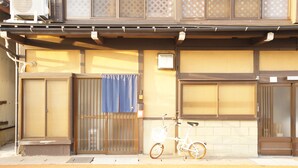 A traditional Japanese building with a bicycle parked outside.