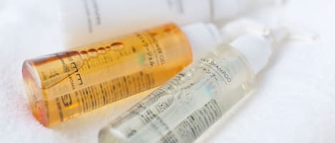 Three bottles of hair care products on a white surface.