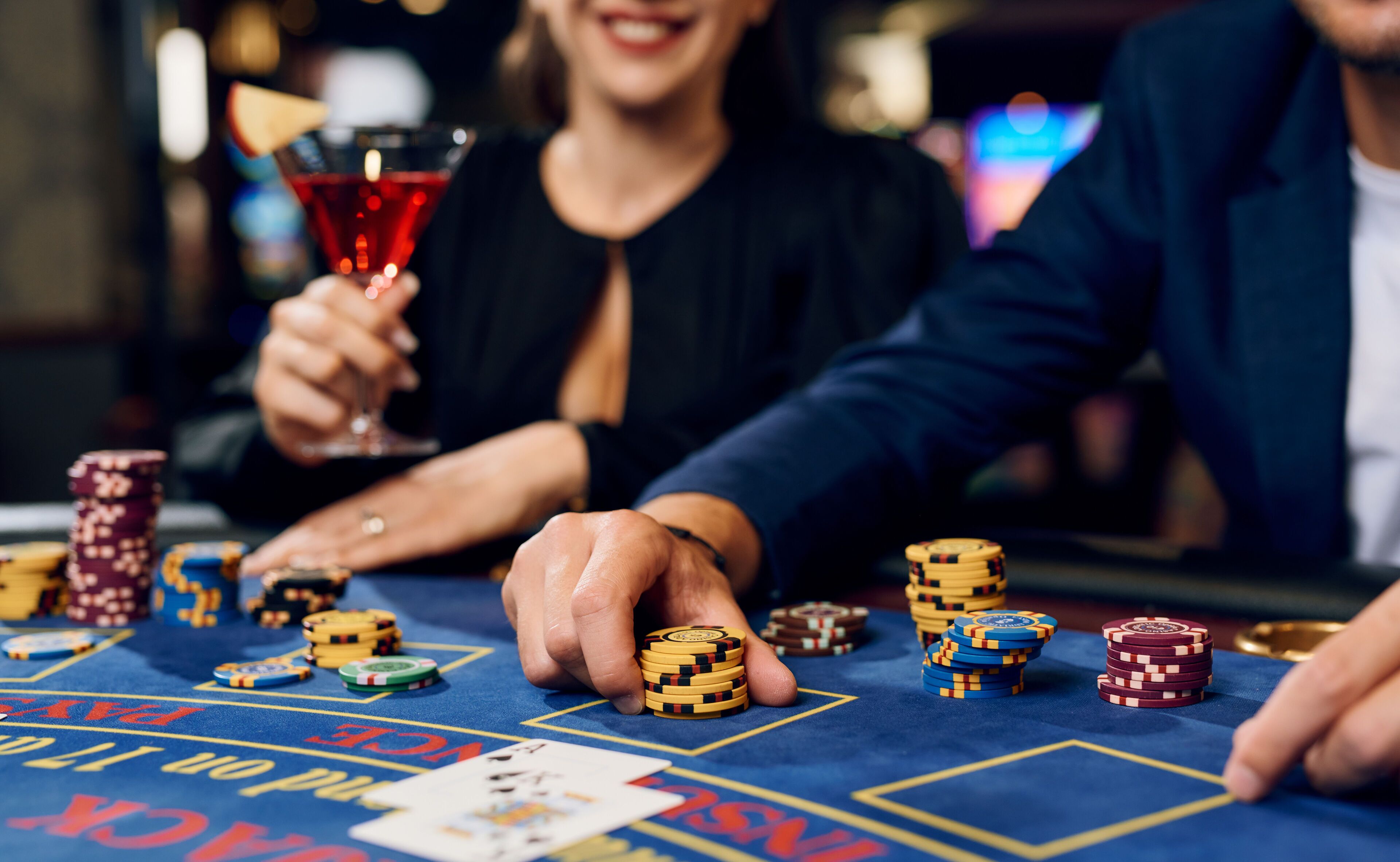 A casino table with poker chips and playing cards.