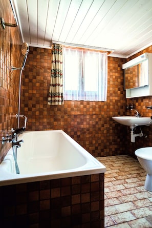 A bathroom with a bathtub, sink, and toilet.