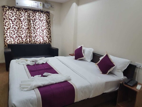 Deluxe Room, City View | In-room safe, iron/ironing board, rollaway beds, bed sheets - Hotel Nanda (Port Blair)