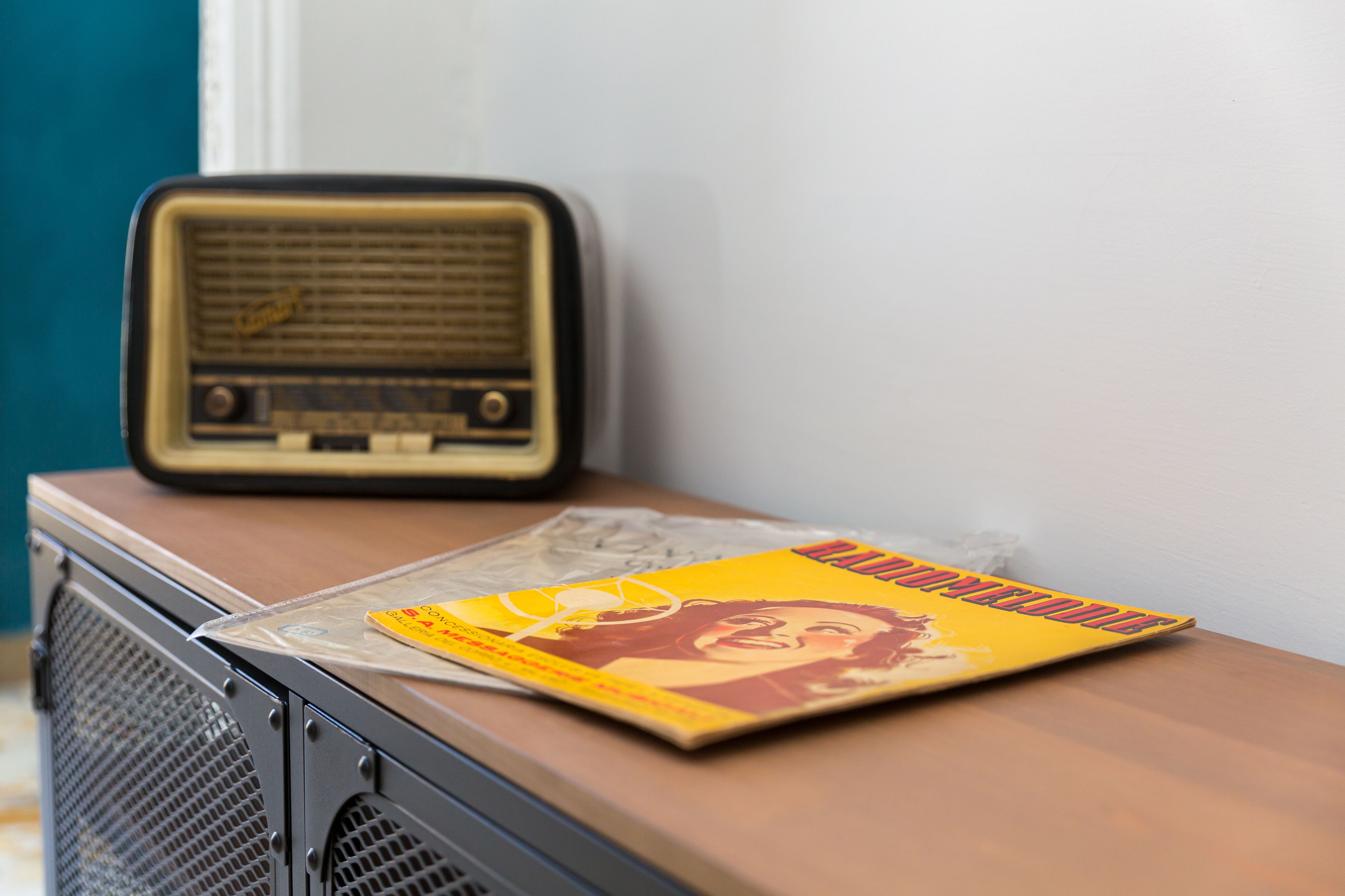 A vintage radio and a magazine on a wooden surface.
