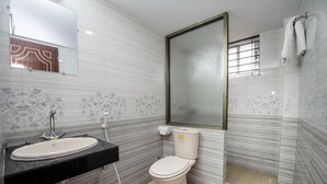 A bathroom with a sink, toilet, and a mirror. - Hotel Ali Plaza (Sylhet)