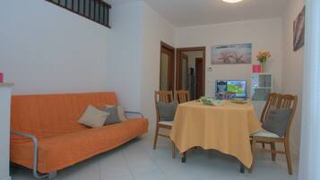 Apartment, 4 Bedrooms, Garden View | Living area | Flat-screen TV