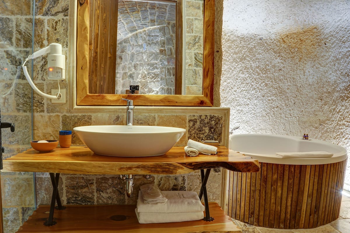 deluxe suite | bathroom | shower, rainfall showerhead, designer toiletries, hair dryer