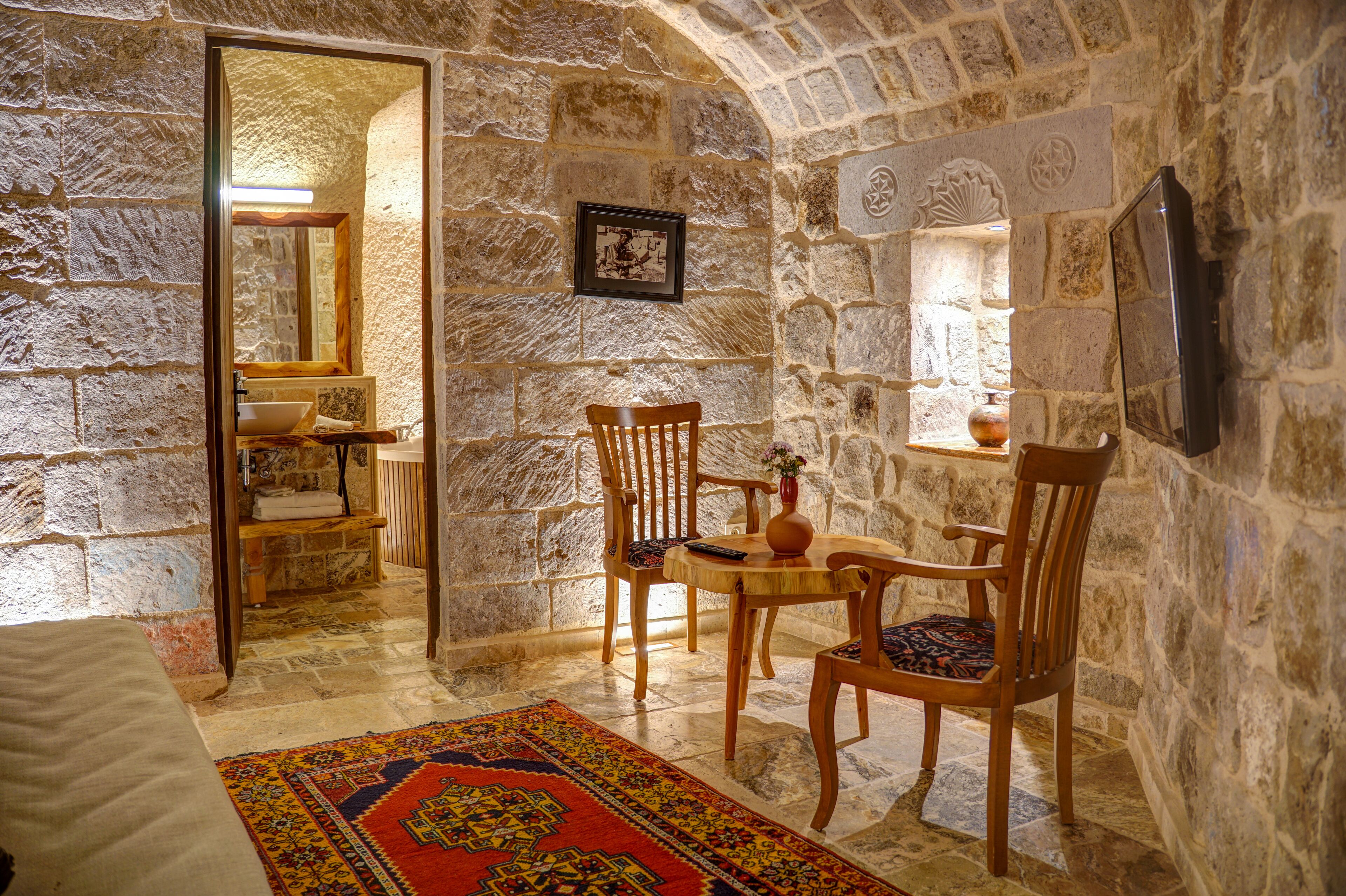 deluxe suite | living area | 102-inch led tv with satellite channels, tv